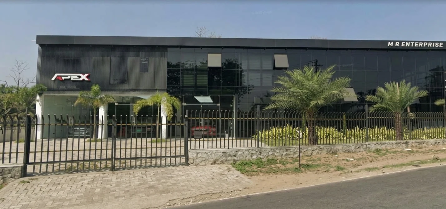 Completed workshop facade with black cladding, showroom glazing and planting