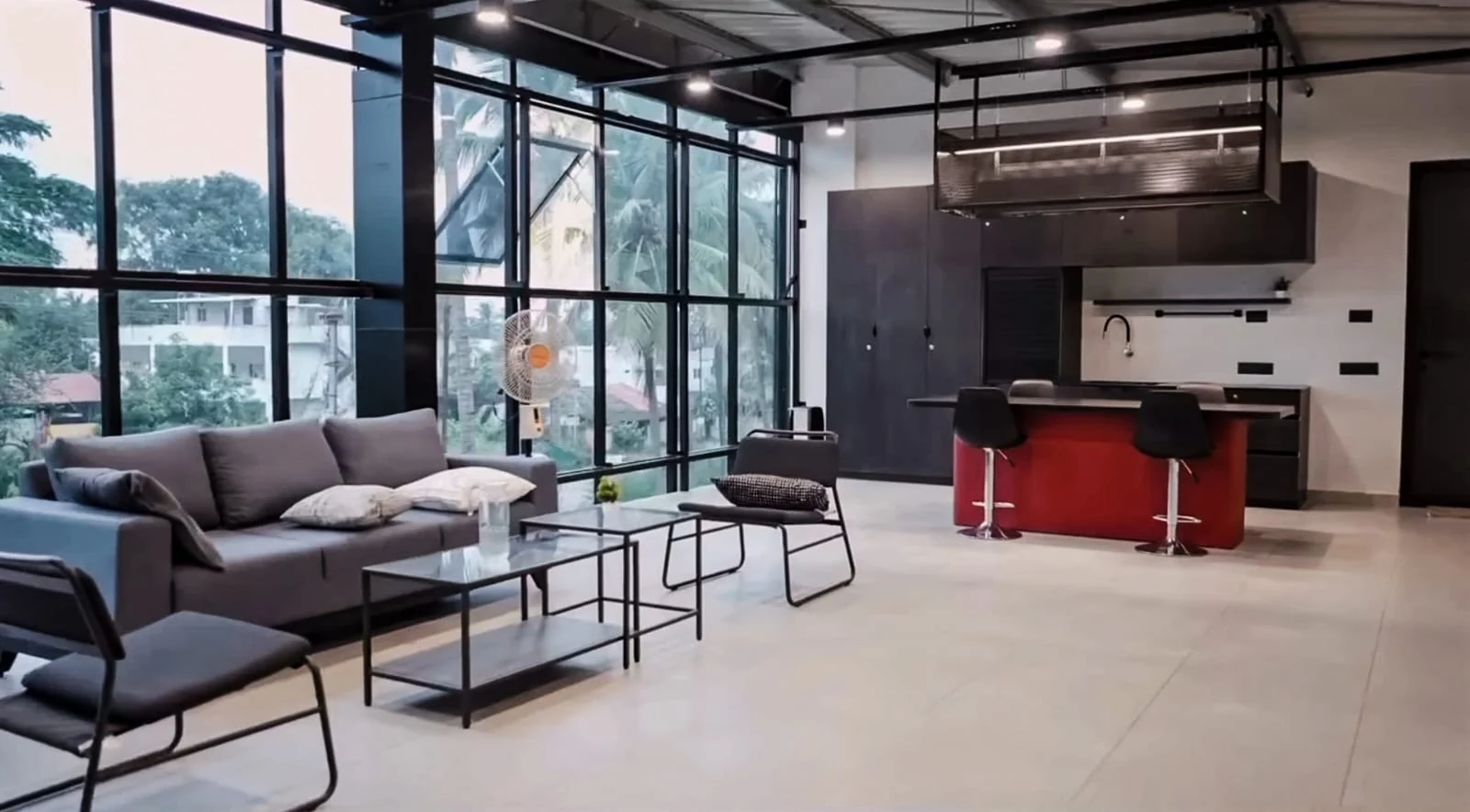 Completed customer lounge with seating, glazed walls and a red counter