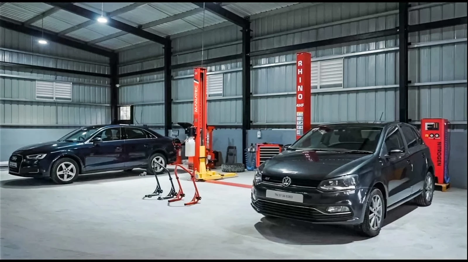 Automotive workshop with service bays, lifts and cars